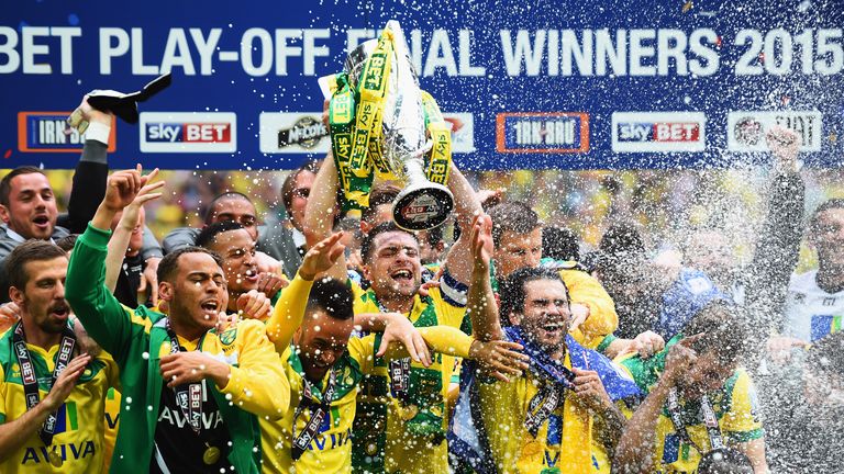 Winning captain Russell Martin of Norwich City celebrates with the trophy alongside team mates after the Sky Bet Championship Pl