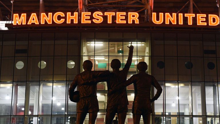 A general view outside Old Trafford stadium and 'The United Trinity' statue of former Manchester United 