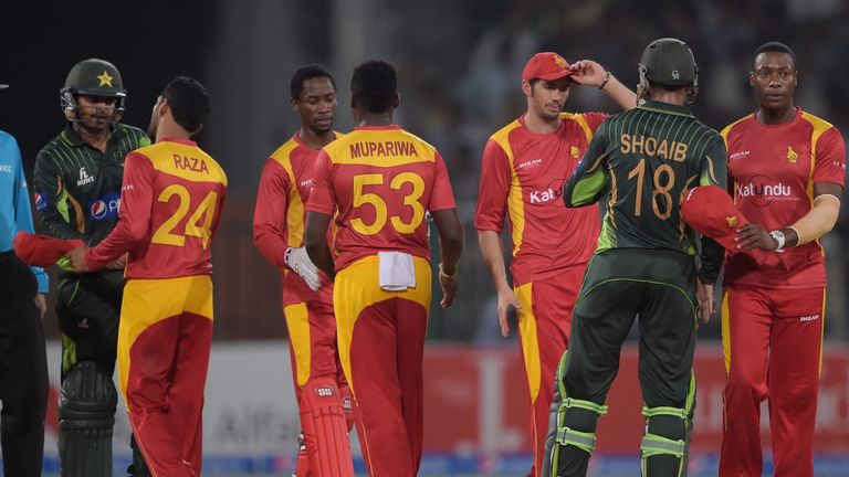 Pakistani cricketers Shoaib Malik (2-R) and Haris Sohail (L) at the end of the second ODI between Pakistan and Zimbabwe at the Gaddafi Stadium in Lahore