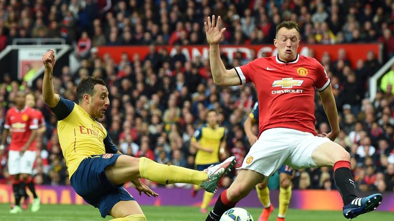  Phil Jones tackles Arsenal's  Santi Cazorla during  Manchester United and Arsenal at Old Trafford on May 17, 2015. 