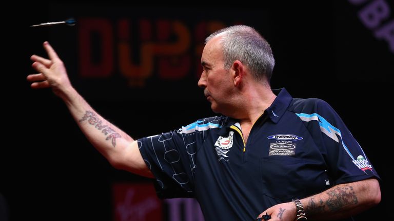 Phil Taylor of England in action against Peter Wright of Scotland during the 2015 Dubai Duty Free Darts Masters 