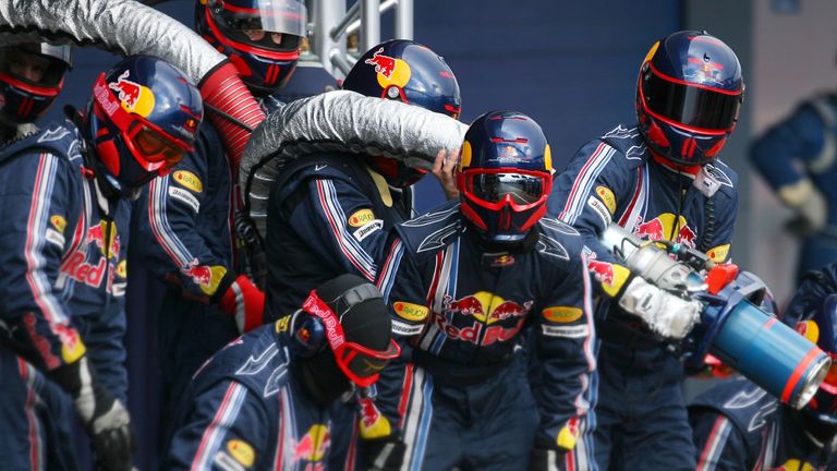 Red Bull's mechanics prepare for a fuel stop in 2009