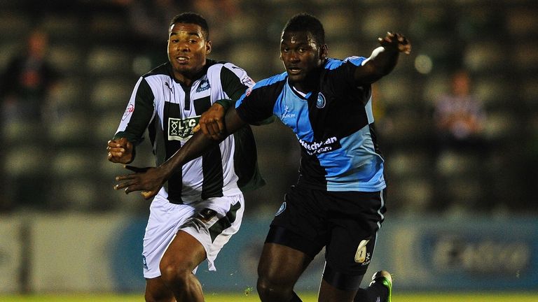 Reuben Reid of Plymouth Argyle (L) battles for the ball with Aaron Pierre of Wycombe Wanderers 