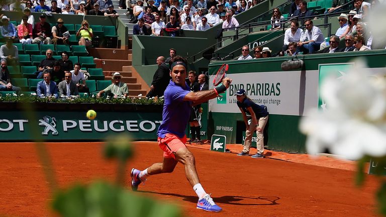 Roger Federer of Switzerland plays a backhand in his Men's Singles match against Marcel Granollers of Spain