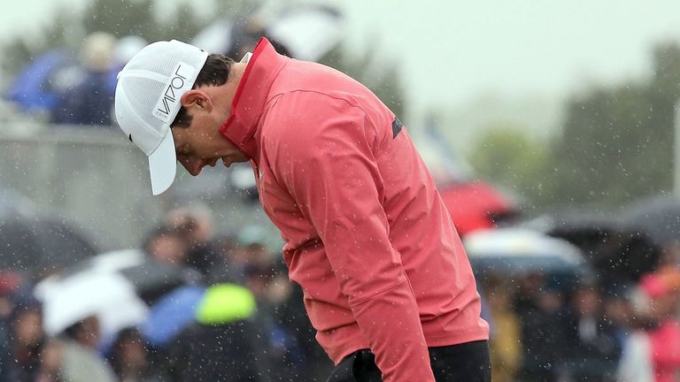 Northern Ireland golfer Rory McIlroy reacts after missing a putt on the 18th green on the first day of the Irish Open at the Royal County Down Golf Club