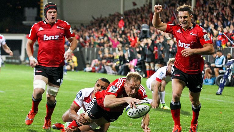 Andy Ellis holds off Will Genia to score the Crusaders' opening try