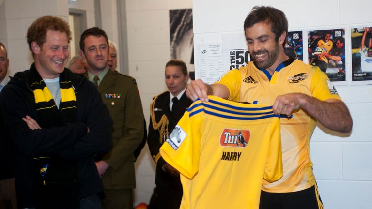 Hurricanes captain Conrad Smith presents Prince Harry with a personalised jersey