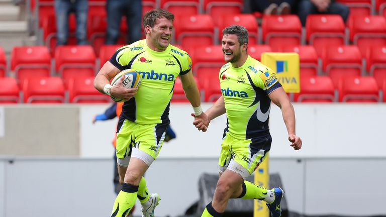 Mark Cueto celebrates with Tom Brady after scoring Sale's second try against Newcastle