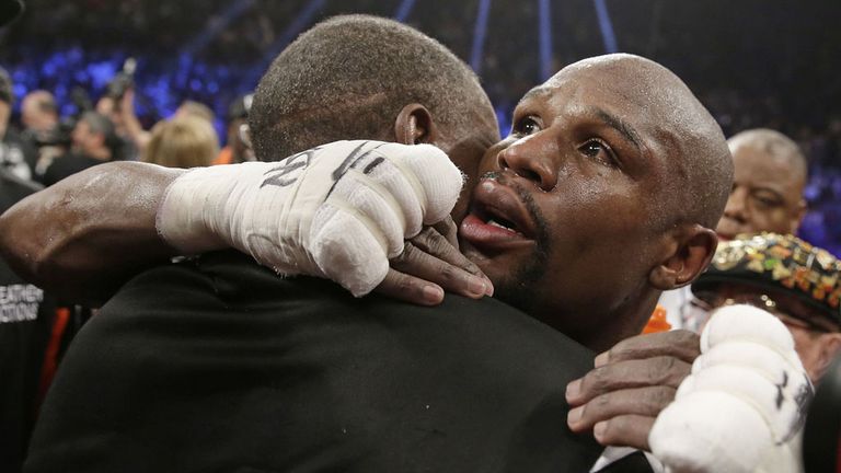 Floyd Mayweather Jr., right, is embraced by his father, head trainer Floyd Mayweather Sr., at the finish of his  fight against Manny Pacquiao