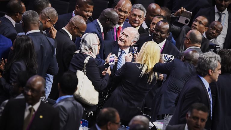 FIFA President Sepp Blatter (C) is greeted by delegates after being re-elected