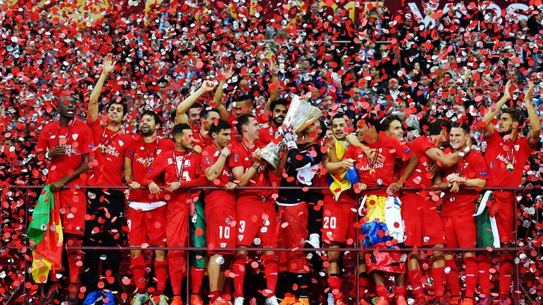 Sevilla's players celebrate with the Europa League trophy