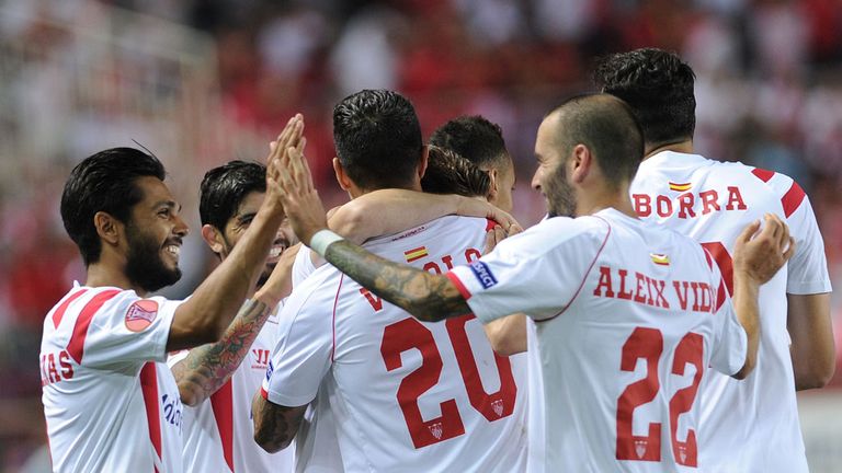 Sevilla's French defender Benoit Tremoulinas (L) and teammates celebrate Gameiro's goal