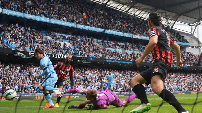 David Silva of Manchester City scores his team's sixth goal past the outstretched Robert Green of QPR.