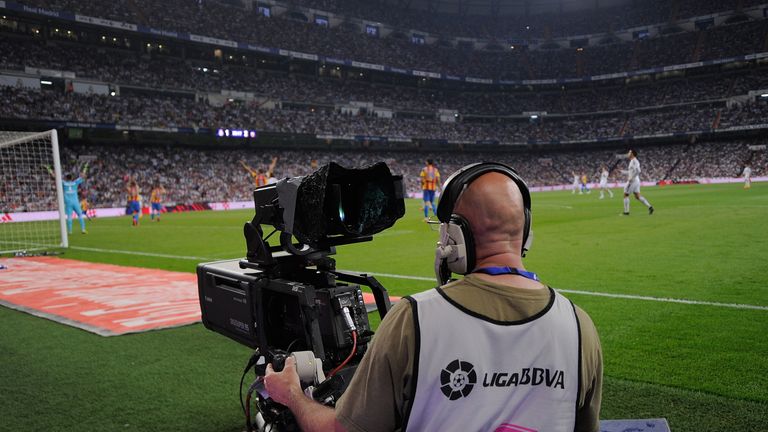 A camera operator films the La Liga match between Real Madrid CF and Valencia CF at the estadio Santiago Bernabeu 