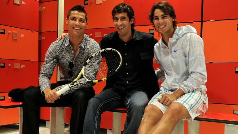 Cristiano Ronaldo (L) and Raul Gonzalez (C) of Real Madrid chat with Rafael Nadal at the Madrid Open