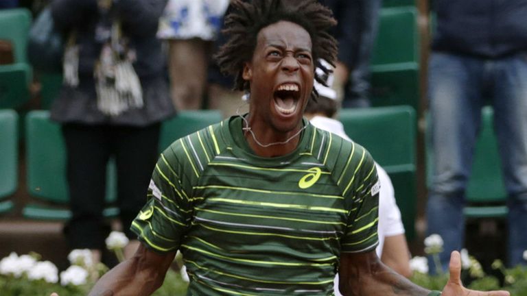 Gael Monfils celebrates after winning his match against Pablo Cuevas at the French Open