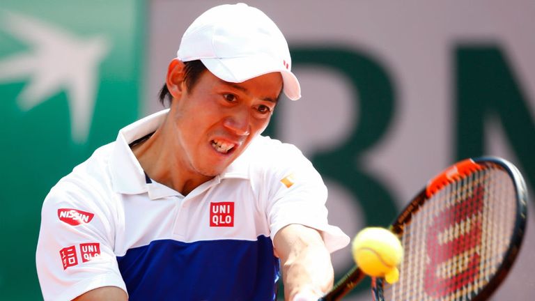 Kei Nishikori plays a backhand during his match against Thomaz Bellucci during day four of the 2015 French Open