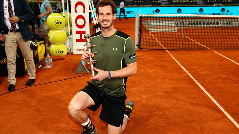 Andy Murray poses with his winners trophy after his straight sets victory against Rafael Nadal at Mutua Madrid Open