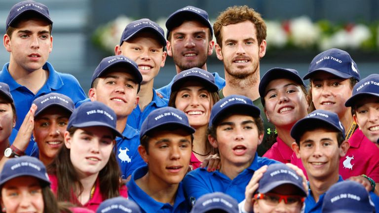 Andy Murray alongside the ball boys and girls after his win at the Mutua Madrid Open