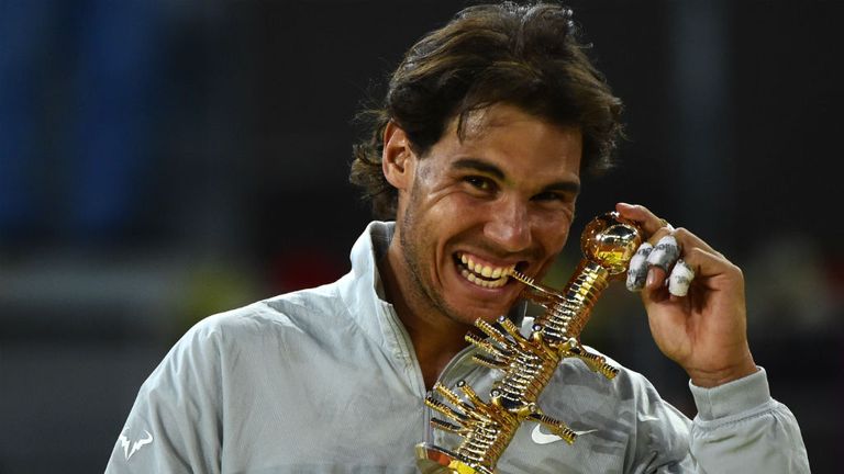 Rafael Nadal poses with the trophy after winning the final against Japanese player Kei Nishikori at the Madrid Masters
