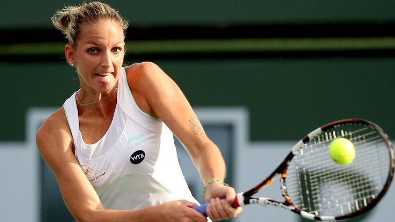 Karolina Pliskovareturns a shot to Simona Halep during the BNP Paribas Open at Indian Wells