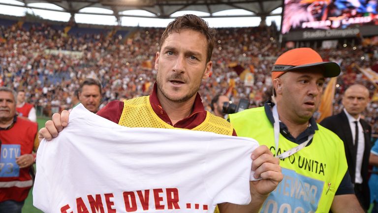 Francesco Totti celebrates with a shirt reading 'game over' after the final whistle