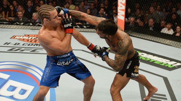 Francisco Rivera punches Urijah Faber in their bantamweight bout during the UFC 181 event inside the Mandalay Bay Events Center