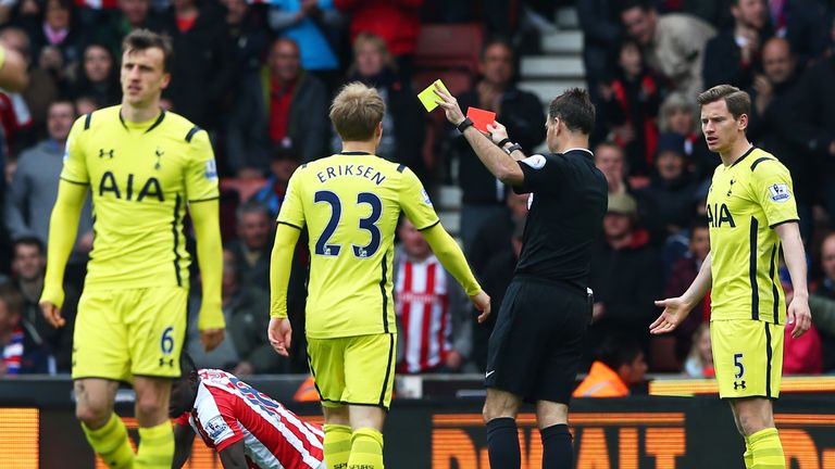 Vlad Chiriches leaves the field after being shown the red card by referee Mark Clattenburg