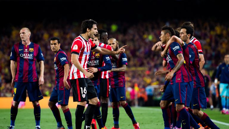 Xabier Etxeita (C) of Athletic Bilbao hits out at Neymar during the Copa del Rey final.