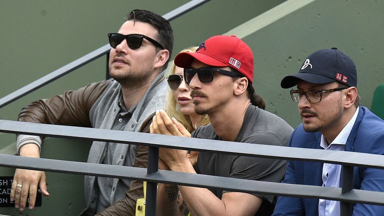 Swedish football player Zlatan Ibrahimovic (C) watches the match between Serbia's Novak Djokovic and Luxemburg's Gilles Muller