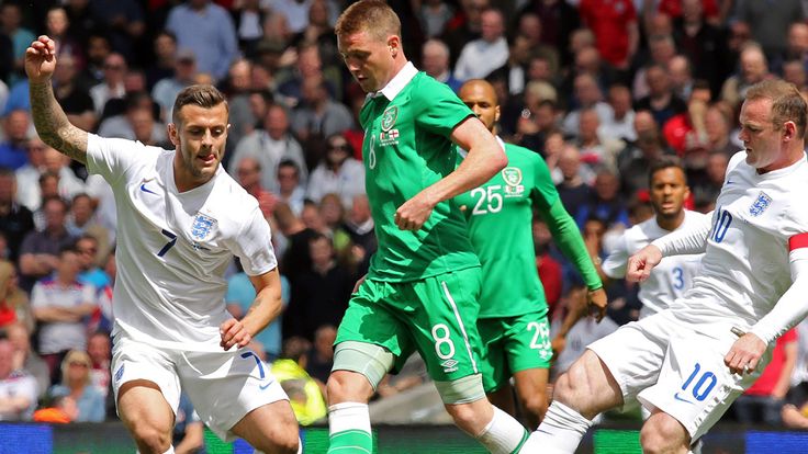 Republic of Ireland's midfielder James McCarthy fights for the ball with Jack Wilshere and Wayne Rooney