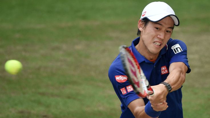 Kei Nishikori plays a backhand in the half final match against Roger Federer during the Gerry Weber Open