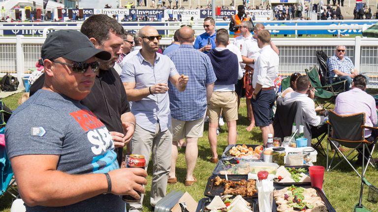 Racegoers enjoy a picnic