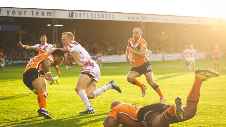 St Helens' Adam Swift is tackled by Castleford's Ben Roberts