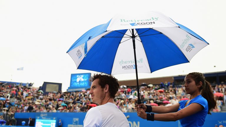  Andy Murray of Great Britain shelters from the rain in his men's singles semi-final match against Viktor Troicki of Serbia