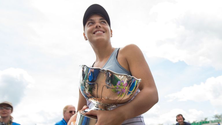 Ana Konjuh of Croatia walks off court with the Elena Baltacha Trophy on day eight of the WTA Aegon Open Nottingham