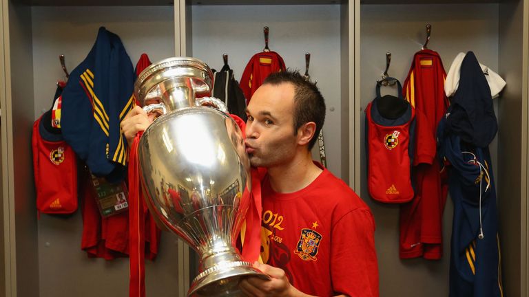 Andres Iniesta of Spain poses in the dressing room with the trophy following the UEFA EURO 2012 final match between Spain and Italy