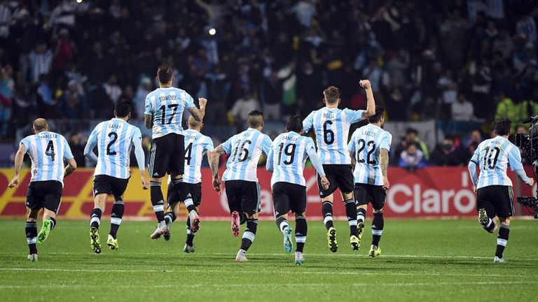 Argentina players celebrate as Carlos Tevez scores the winning penalty. 