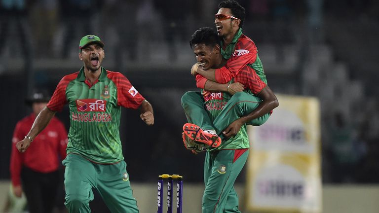 Bangladesh cricketer Mustafizur Rahman (C) celebrates with his teammate Nasir Hossain