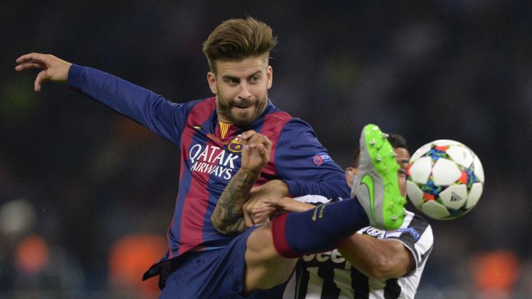 Barcelona defender Gerard Pique and Juventus forward Carlos Tevez vie for the ball during the UEFA Champions League Final