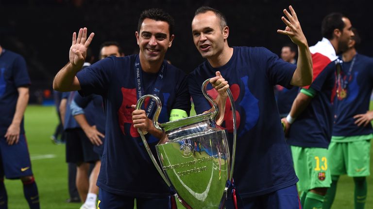 Barcelona's Xavi Hernandez and Andres Iniesta celebrate with the trophy after the UEFA Champions League Final football match against Juventus in June 2015