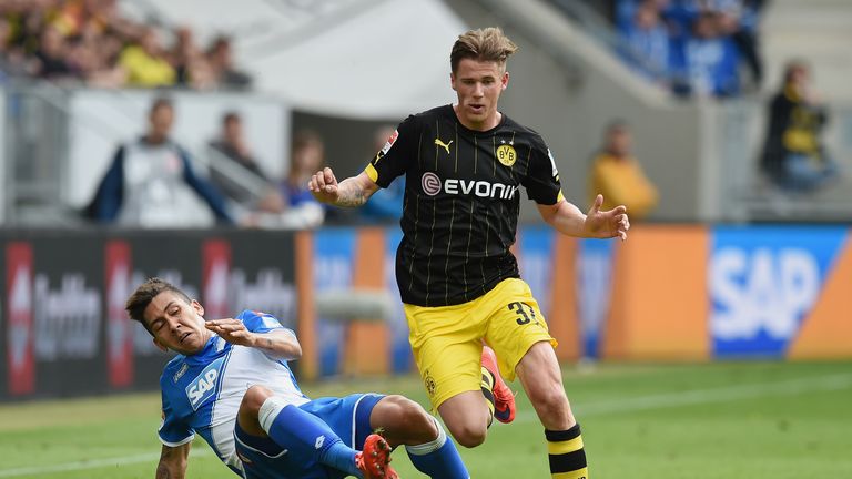 Erik Durm (R) of Dortmund is challenged by Roberto Firmino (L) of Hoffenheim