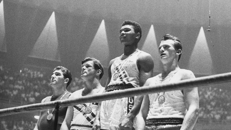 The winners of the 1960 Olympic medals for light heavyweight boxing on the winners' podium at Rome: Cassius Clay (now Muhammad Ali) (C), gold; Zbigniew Pie