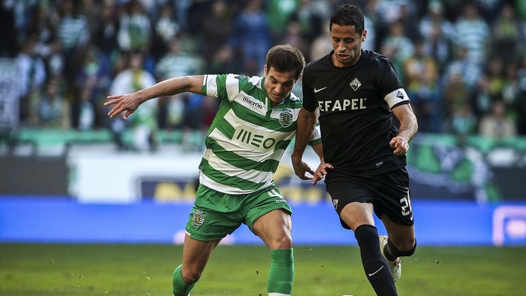 Sporting's defender Cedric Soares (L) vies with Academica's midfielder Nuno Piloto (R) during the Portuguese league football match 