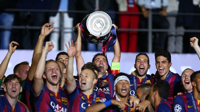 Xavi of Barcelona lifts the trophy as he celebrates victory with team mates after the UEFA Champions League Final between Juventus and FC Barcelona