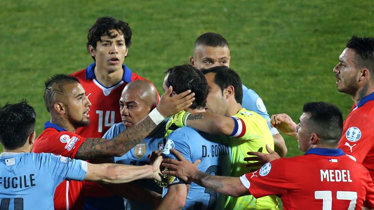 Chile's midfielder Arturo Vidal and Uruguay's defender Diego Godin argue