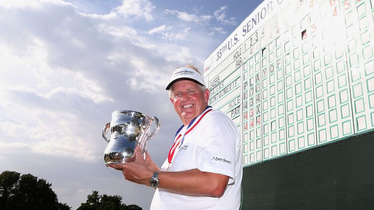 Colin Montgomerie of Scotland poses with the winner's trophy after winning the 2014 U.S. Senior Open Championship in the final round