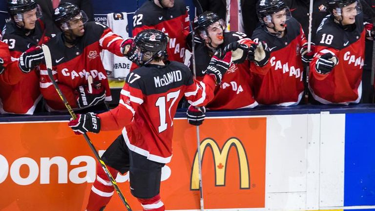 Connor McDavid celebrates with his Canada team-mates