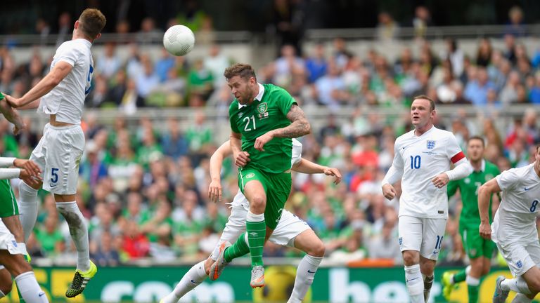 Ireland forward Daryl Murphy (c) heads wide against England