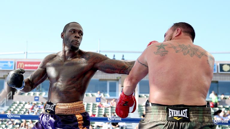 LOS ANGELES, CA - AUGUST 16:  Deontay Wilder (L) lands a punch on Jason Gavern in their heavywieght fight at StubHub Center on August 16, 2014 in Los Angel